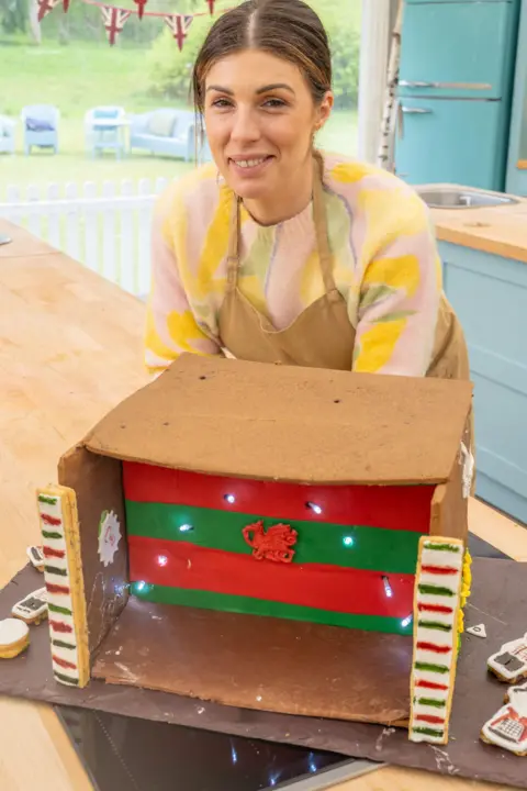 Channel 4/Love Productions/Mark Bourdillon Bake Off winner Georgie Grasso with a Welsh-themed cake, including a red dragon at the front