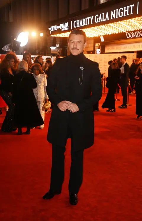 Alan Chapman/Dave Benett/Getty Images Luke Evans wears all black on Devil Wears Prada: The Musical red carpet