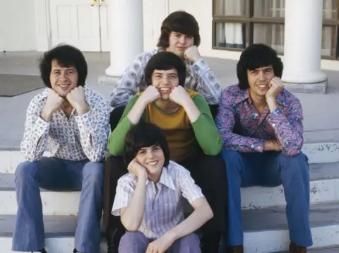 Getty Images The Osmonds, circa 1972. Front; Donny. Centre, left to right: Wayne, Jay and Alan. Back; Merrill.